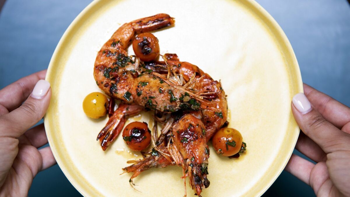 Gambas a la Plantxa features griddled blue prawns, cherry tomato, garlic and brandy de jerez.