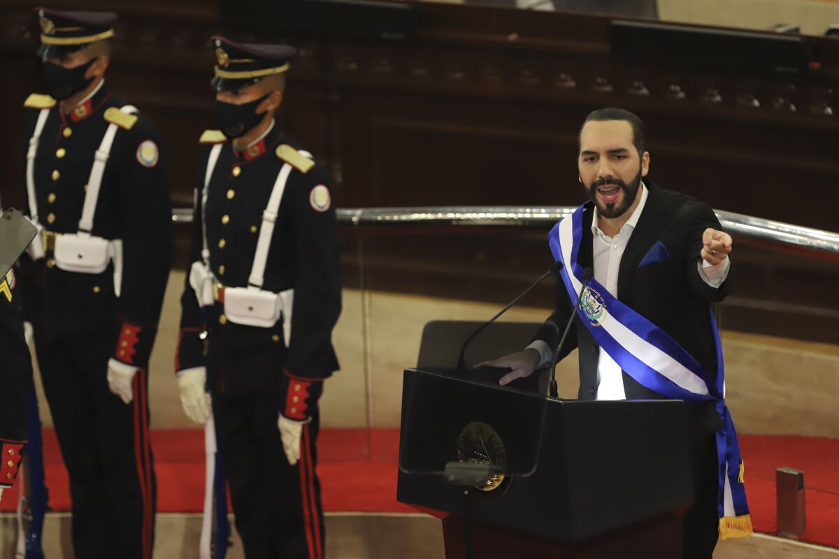 President Nayib Bukele speaks into a microphone at a podium