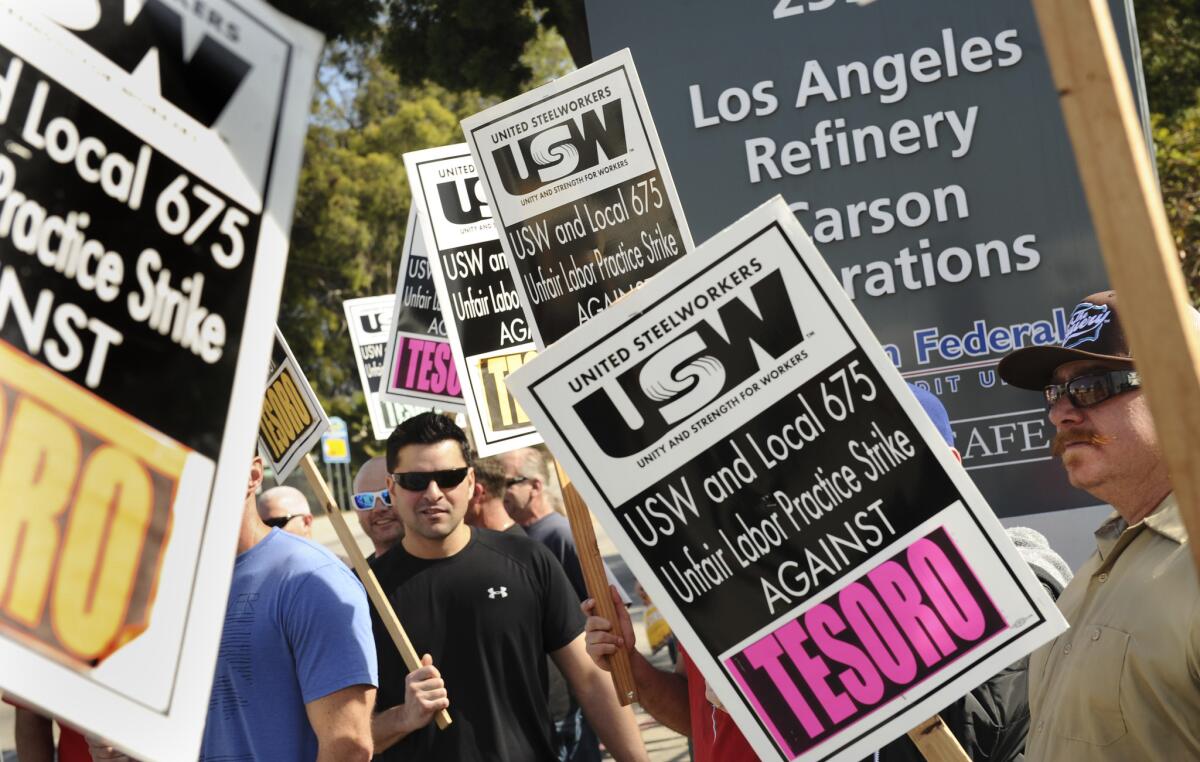 United Steelworkers picket outside the Tesoro refinery in Carson last month, when the USW launched a nationwide strike against Shell Oil.