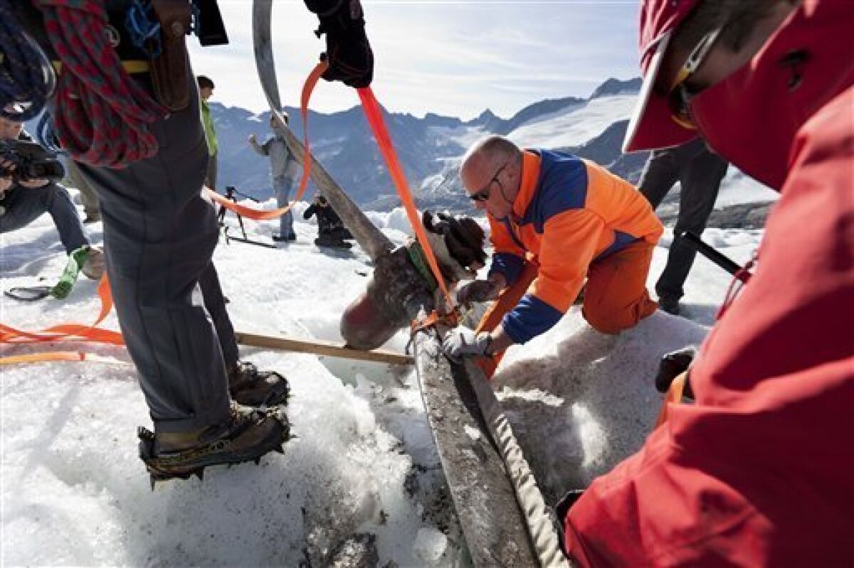 Mountain rescuers recover the propeller of US warplane C-53 Skytrooper “Dakota” that crashed in 1946, on the Gauli glacier in the Bernese Alps, Switzerland, Thursday Aug. 9, 2012. Three young climbers discovered a propeller piece of the legendary airplane at the end of July 2012. The Dakota crash on the Gauli Glacier on Nov. 19, 1946 was a turning point in alpine rescue and an international media event. The aircraft, coming from Austria bound for Italy, collided with the Gauli glacier in poor visibility. On board were four crew members and eight passengers. Among the eight passengers were high-ranking officers of the U.S. armed forces with some of their relatives. Several people were injured, but there were no fatalities. The propeller will be transported to the near Gauli cabin. (AP Photo/Keystone, Gaetan Bally)