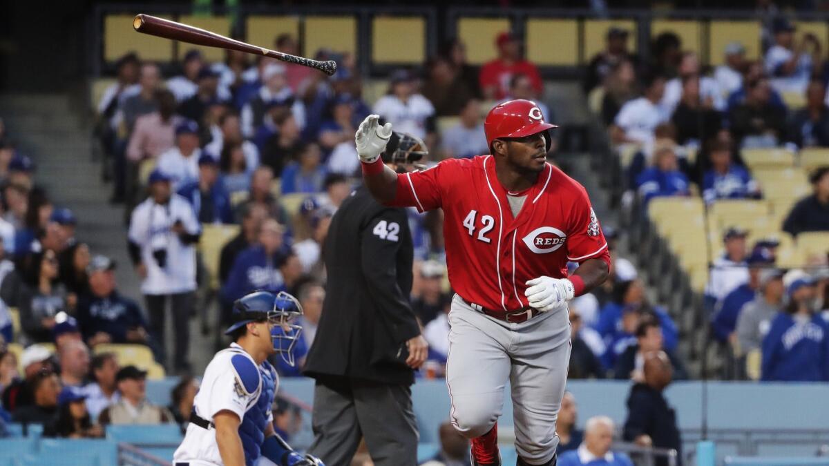 Cincinnati Reds outfielder Yasiel Puig flips his bat after hitting a two-run home run off Clayton Kershaw during the first inning of the Dodgers' 4-3 victory Monday.