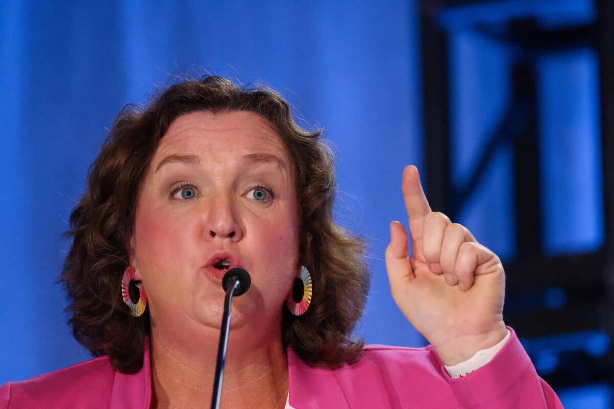 Rep. Katie Porter points up while participating in a debate
