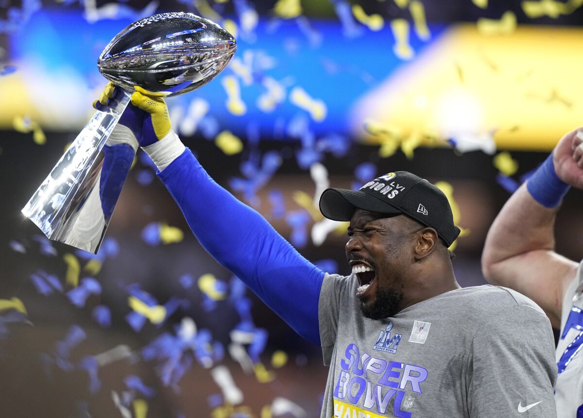 Los Angeles Rams outside linebacker Von Miller holds up the Lombardi Trophy after the Rams defeated the Cincinnati Bengals in the NFL Super Bowl 56 football game Sunday, Feb. 13, 2022, in Inglewood, Calif. (AP Photo/Lynne Sladky)