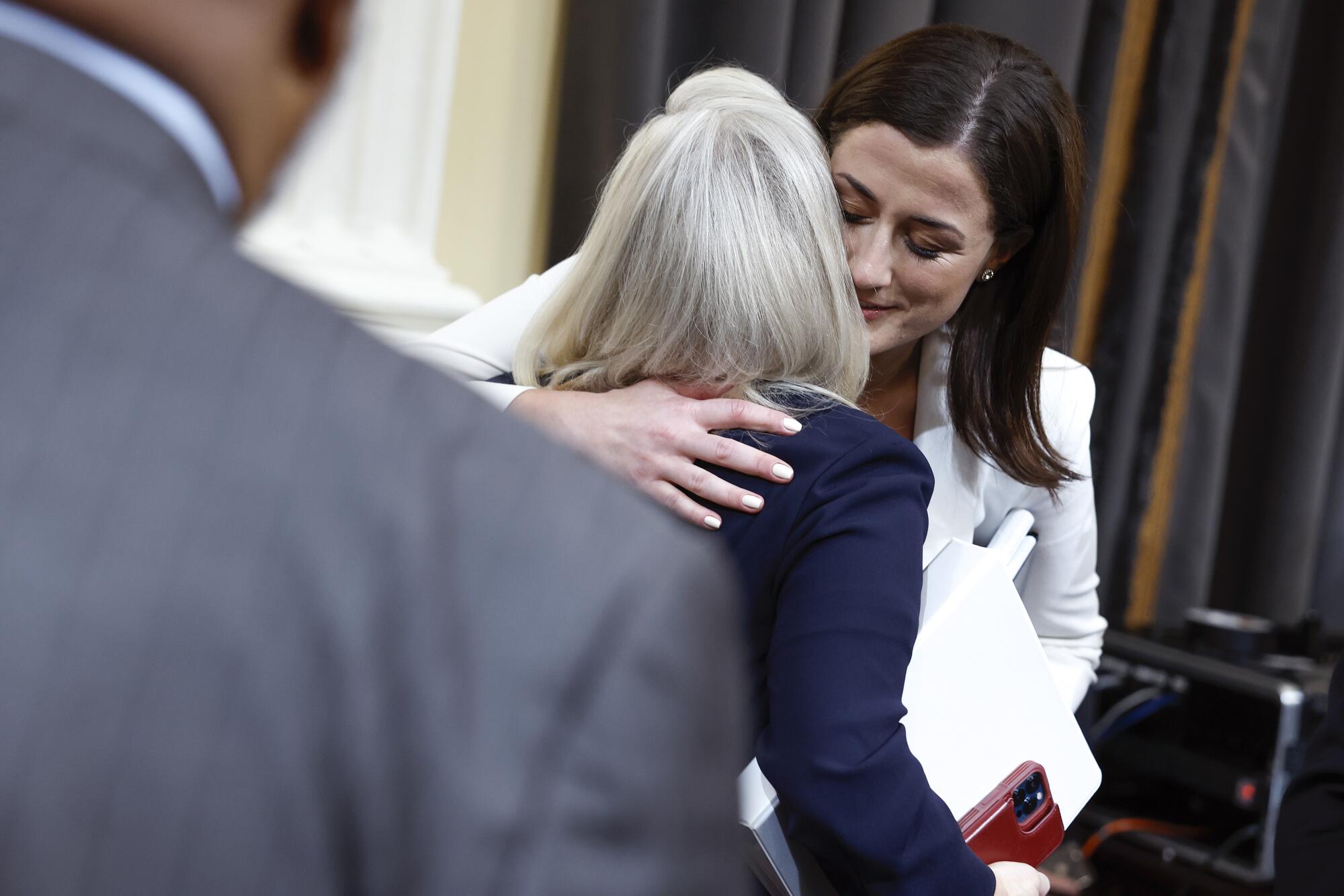 Hutchinson hugs U.S. Rep. Liz Cheney (R-WY) after testifying during the sixth hearing by the House Select Committee 