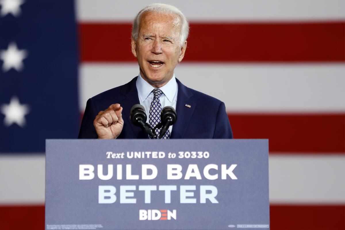 Biden stands at a lectern with Build Back Better sign.