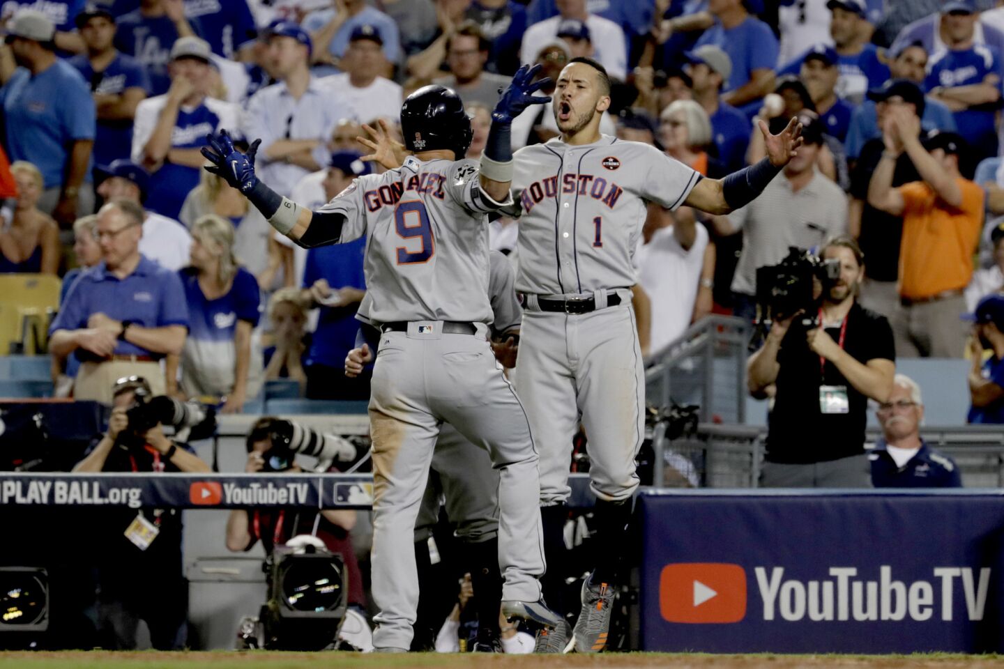 Astros shortstop Carlos Correa greets teammate Marwin Gonzalez after he hit a solo home run off Dodgers closer Kenley Jansen in the ninth inning to tie the score, 3-3, and force extra innings.
