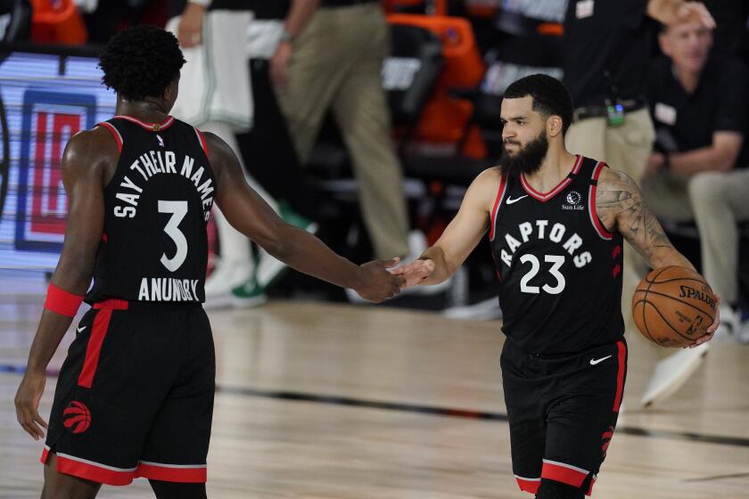 The Raptors' Fred VanVleet (23) celebrates with teammate OG Anunoby during Toronto's win over Boston on Sept. 5, 2020.