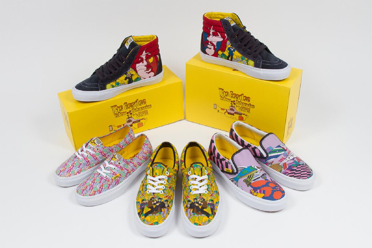 Four pairs of brightly colored, boldly patterned sneakers and two yellow shoeboxes.