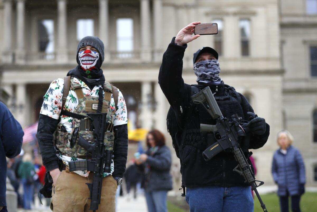 Protesters with rifles outside the state Capitol in Lansing, Mich.