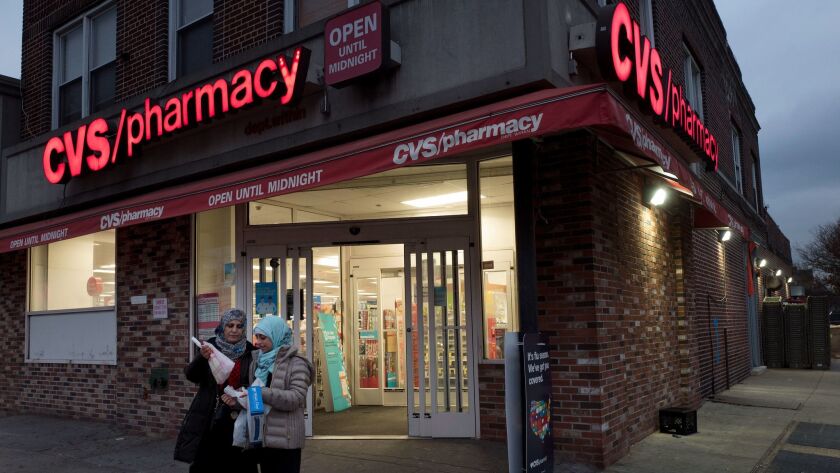 Customers leave a CVS Pharmacy in New York on Dec. 3.