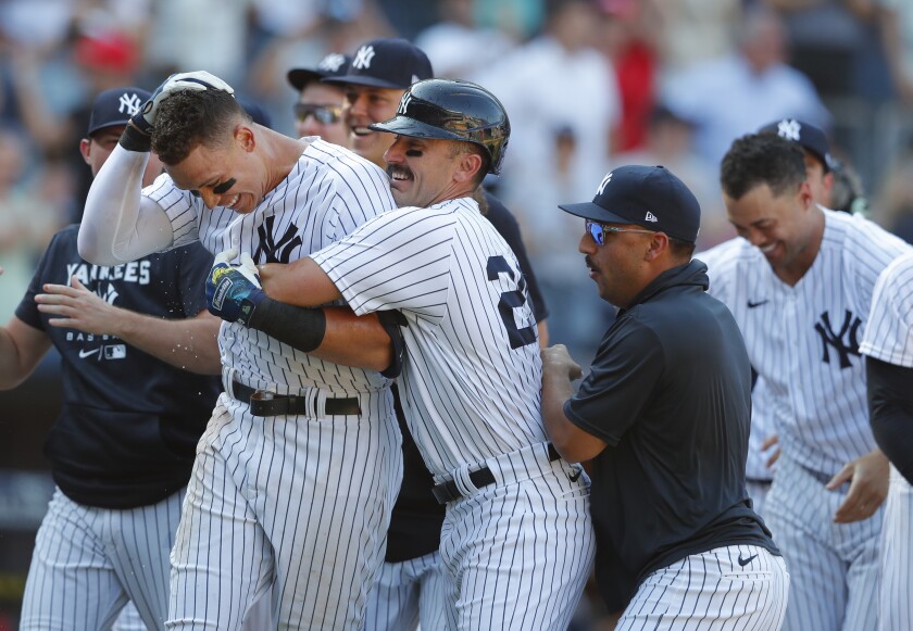 New York Yankees right fielder Aaron Judge (99) celebrates with New York Yankees second baseman Matt Carpenter (24) after hitting a game-winning home run against the Houston Astros during the 10th inning of a baseball game, Sunday, June 26, 2022, in New York. The New York Yankees won 6-3. (AP Photo/Noah K. Murray)