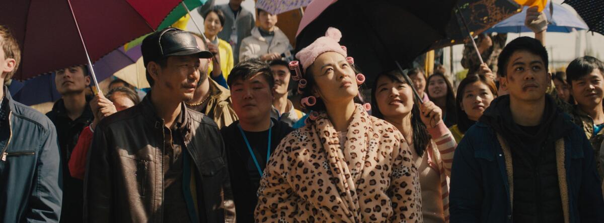 Haoyu Yang, from left, Vivian Wu, in robe and curlers, and Mason Lee in the movie "Dead Pigs."