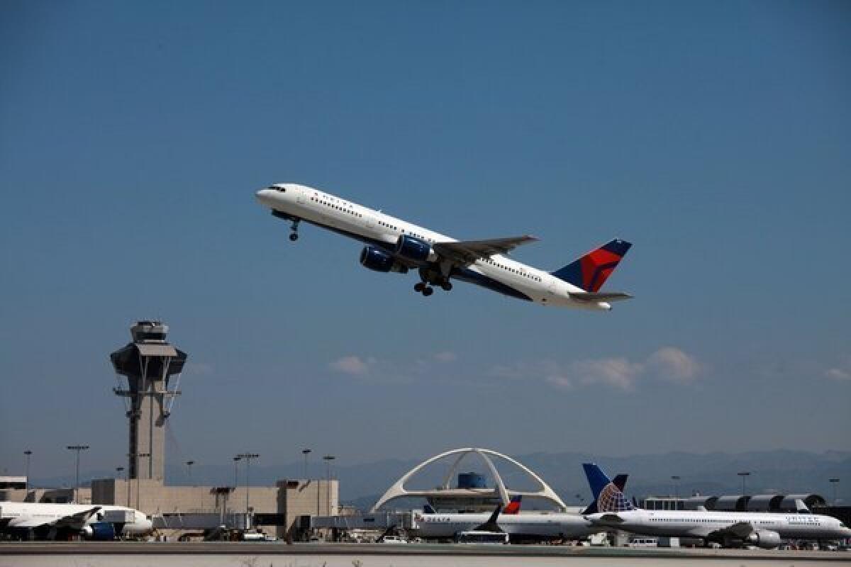 A jet takes off from Los Angeles International Airport. A new law signed Sunday by Gov. Jerry Brown gives statewide authority to officers of the Los Angeles Airport Police Department, which employs about 1,100 sworn and civilian personnel.