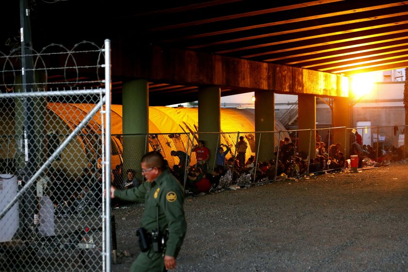 Gary Coronado  Los Angeles Times ASYLUM seekers huddle in El Paso. Rep. Alexandria Ocasio-Cortez has compared migrant detention facilities to concentration camps.
