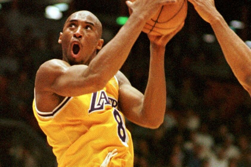 FILE - Los Angeles Lakers' Kobe Bryant (8) of the goes in shot against the Utah Jazz.