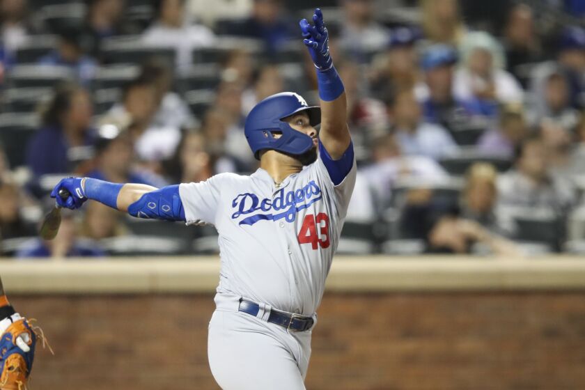 Los Angeles Dodgers' Edwin Rios watches his two-run home run during the eighth inning of the team's baseball game against the New York Mets, Friday, Sept. 13, 2019, in New York. (AP Photo/Mary Altaffer)
