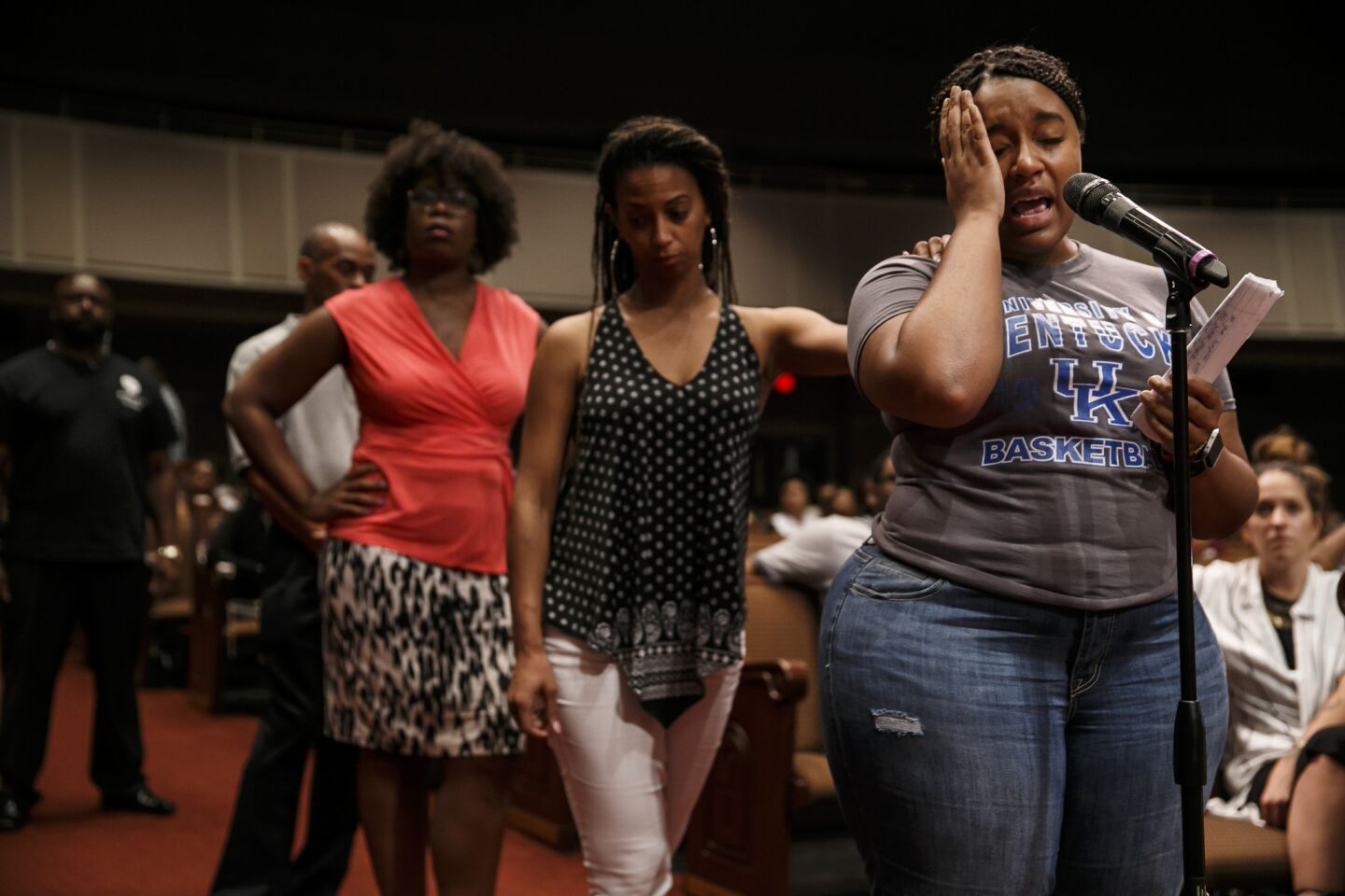 Porsha Jackson, right, speaks during a community meeting at a Dallas church on Sunday.