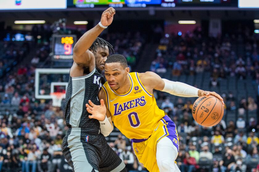 Los Angeles Lakers guard Russell Westbrook (0) tries to drive on Sacramento Kings guard Davion Mitchell.