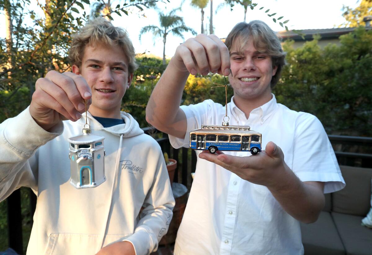 Sawyer and Jackson Collins, from left, hold two ornaments as part of their Iconic Ornaments business.