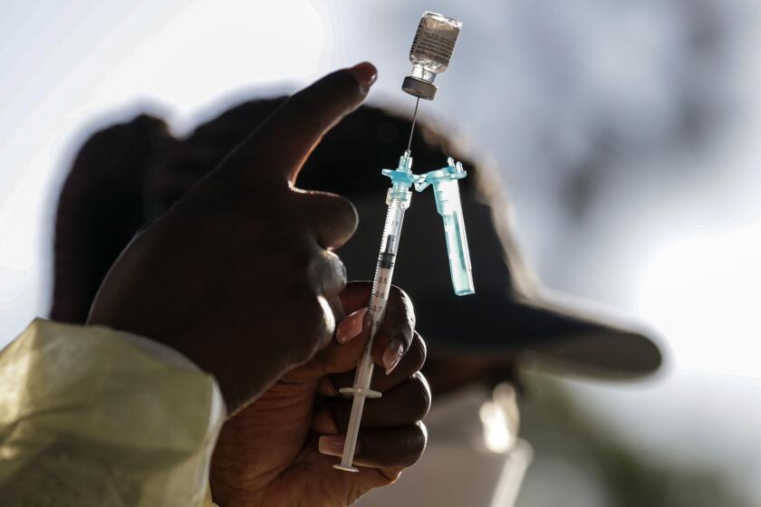 Ontario, CA - February 24: Out of state nurse Leshea Moore, from Michigan, prepares a Pfizer-BioNTech COVID-19 vaccine at Convention Center on Wednesday, Feb. 24, 2021 in Ontario, CA.(Irfan Khan / Los Angeles Times)