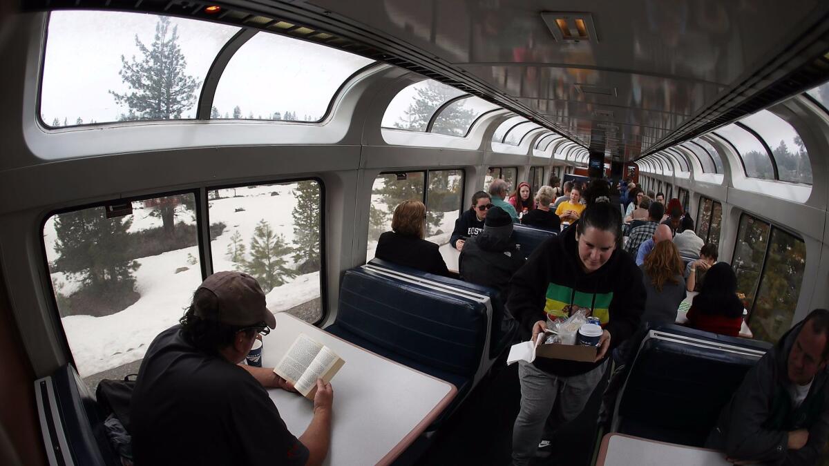 Travelers enjoy the view from Amtrak's California Zephyr sightseer lounge car as it passes through the countryside near Truckee, Calif.