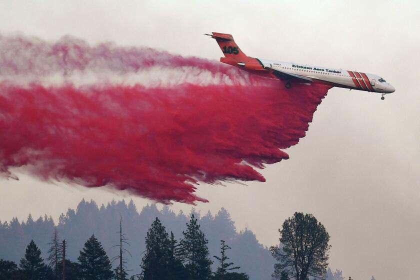 An air tanker drops fire retardent to try to contain flames from the Carr fire as it spreads towards the town of Lewiston near Redding, California, on August 2, 2018. Thousands of firefighters were struggling on August 2 to contain two vast wildfires in California, one of which has become one of the most destructive blazes in the state's history. The Carr Fire has scorched 126,00 acres (51,00 hectares) of land since July 23, when authorities say it was triggered by the "mechanical failure of a vehicle" that caused sparks to fly in tinderbox dry conditions. / AFP PHOTO / Mark RALSTONMARK RALSTON/AFP/Getty Images ** OUTS - ELSENT, FPG, CM - OUTS * NM, PH, VA if sourced by CT, LA or MoD **