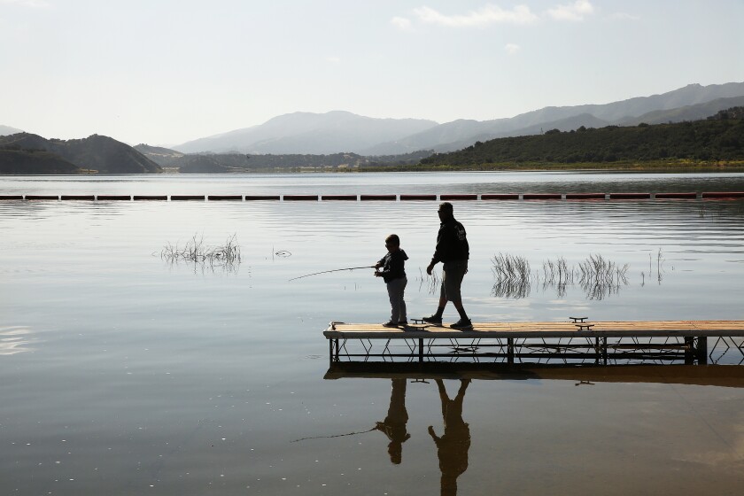 Danny Santistevan and his grandson, Mario Antonio Garcia, 6, fish at Cachuma Reservoir.