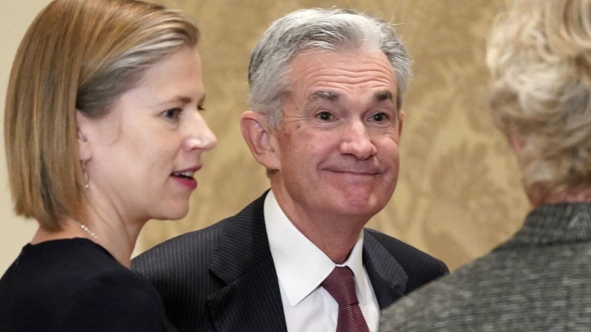 Federal Reserve Chairman Jerome "Jay" Powell, center, could be a topic at your holiday meal. Get ready.