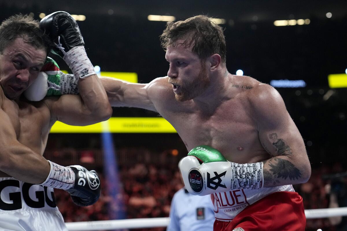 Canelo Alvarez punches Gennady Golovkin in the face during a super middleweight title boxing match