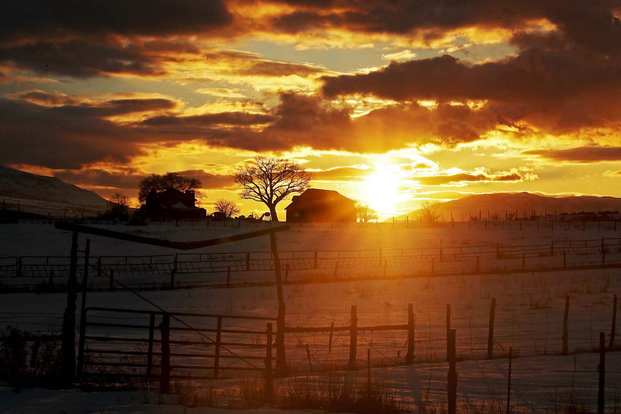 A ranch home and barn are surrounded by fields of snow near Granby.