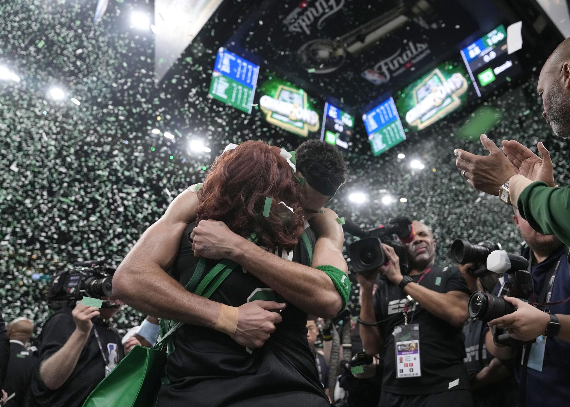 Boston forward Jayson Tatum embraces his mother, Brandy Cole, after the Celtics' championship victory.