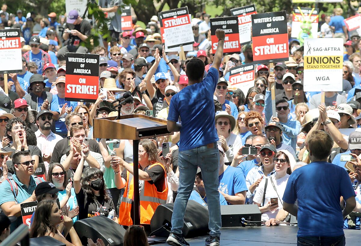 Hundreds of striking members of the Writers Guild of America rally