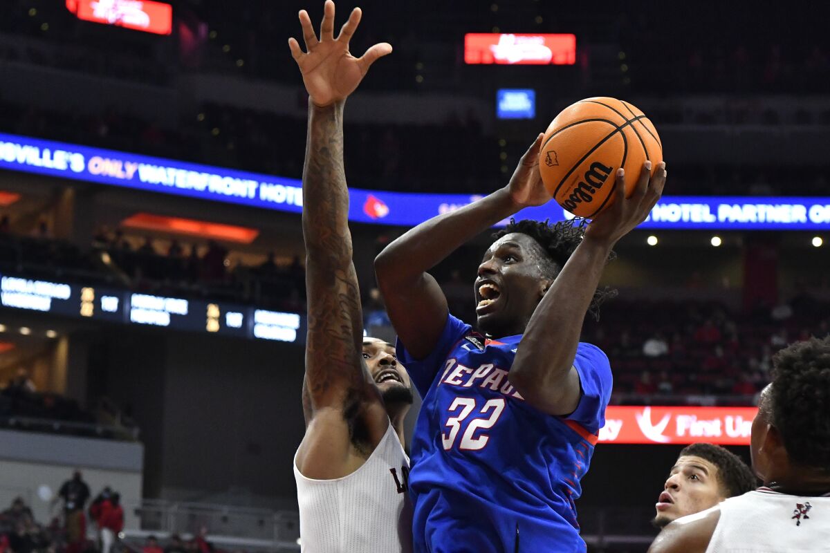 DePaul forward David Jones (32) shoots next to Louisville forward Malik Williams during the first half of an NCAA college basketball game in Louisville, Ky., Friday, Dec. 10, 2021. (AP Photo/Timothy D. Easley)