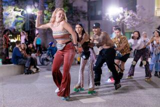 Mackenzie Dent leads a train of skaters at a stop along the rollout portion of Throwback Thursday: A Groovy Roller Disco, an event cohosted by the LA Skate Hunnies and Ivy Station in Culver City on Thursday, July 6, 2023.