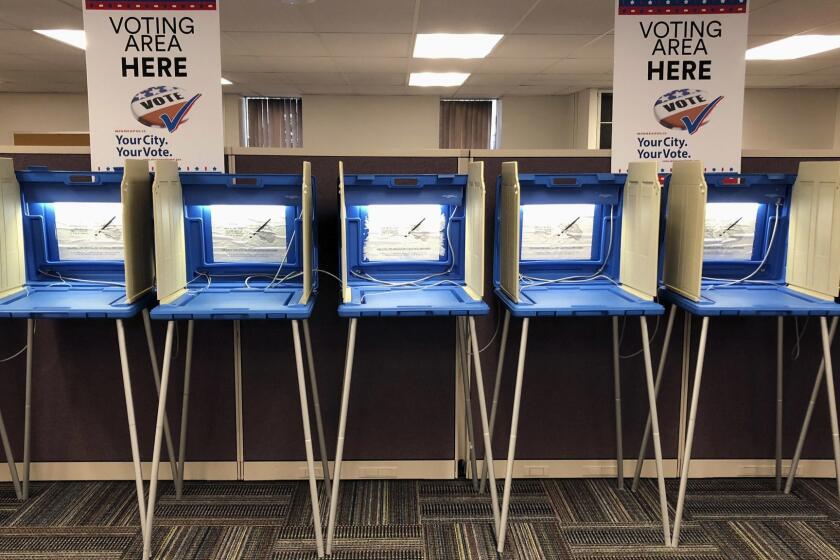 Voting booths stand ready in downtown Minneapolis on Thursday, Sept. 20, 2018, for Friday's opening of early voting in Minnesota. Minnesota and South Dakota are tied for the earliest start in the country for early voting in the 2018 midterm elections. (AP Photo/Steve Karnowski)
