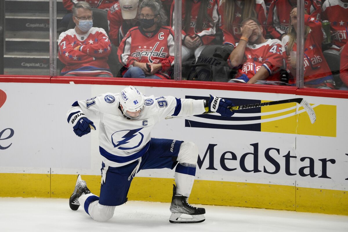 Tampa Bay Lightning center Steven Stamkos (91) celebrates his winning goal in overtime of an NHL hockey game against the Washington Capitals, Saturday, Oct. 16, 2021, in Washington. (AP Photo/Nick Wass)