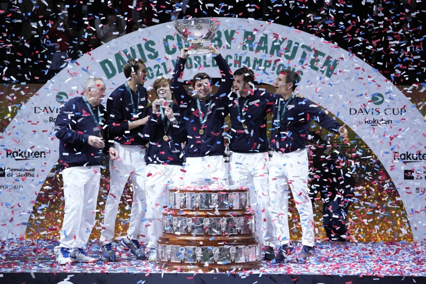 The Russian Tennis Federation team celebrate with the trophy after winning the Davis Cup tennis final at the Madrid Arena in Madrid, Spain, Sunday, Dec. 5, 2021. (AP Photo/Bernat Armangue)