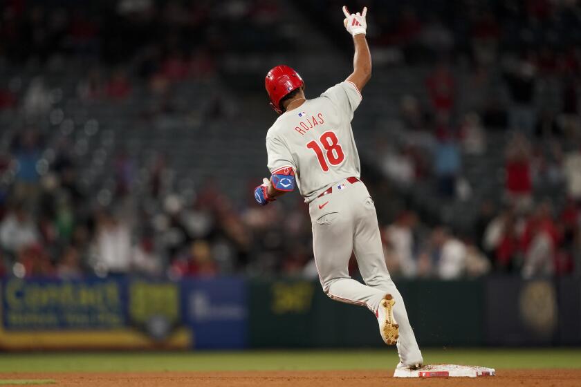 Philadelphia Phillies' Johan Rojas gestures while running the bases after hitting a two-run home run to score Bryson Stott during the ninth inning of a baseball game against the Los Angeles Angels, Tuesday, April 30, 2024, in Anaheim, Calif. (AP Photo/Ryan Sun)