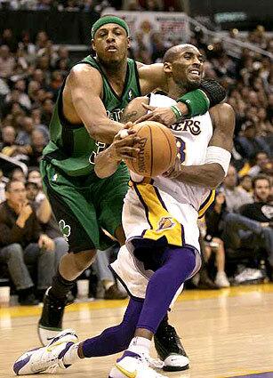 Kobe Bryant gets fouled hard by Boston's Paul Pierce while driving to the basket Sunday during a 112-111 victory for the Celtics.