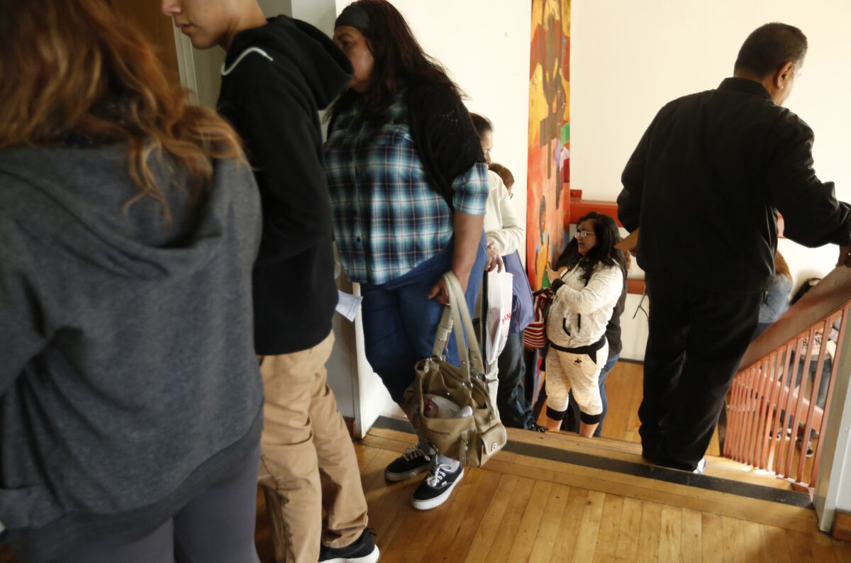 Immigrants wait in line on consultation day at the Central American Resource Center in Los Angeles.