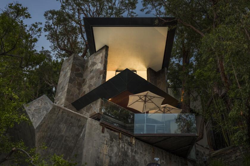 Walls of glass run from floor to ceiling in the John Lautner-designed Wolff House.