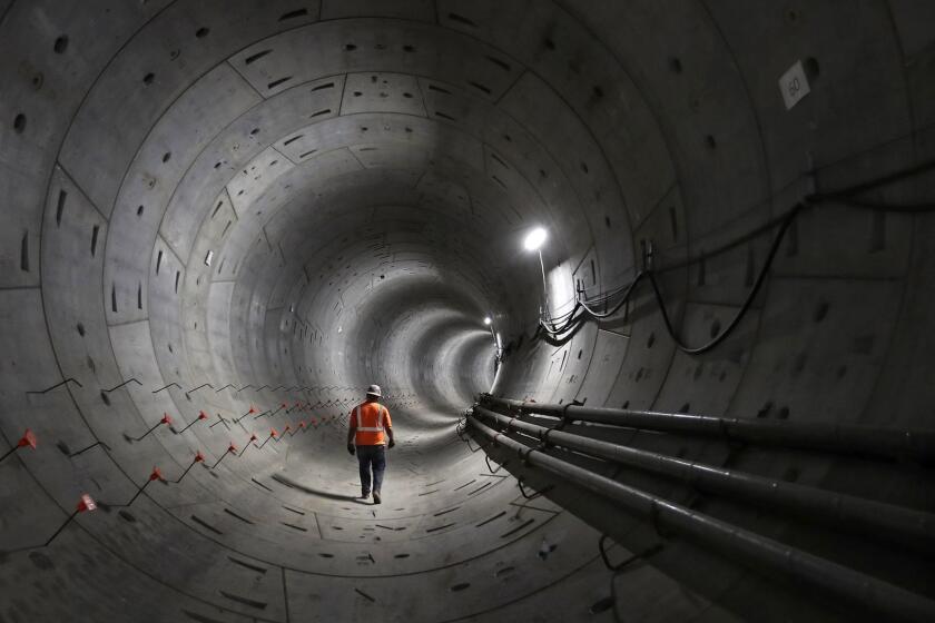 LOS ANGELES, CA-MAY 14, 2018: Miner Jesus Ruiz walks inside a tunnel that is part of the 1.9 mile underground light rail system connecting Metro Rail's Gold Line to the 7th St/Metro Center. The project is now 50 percent complete and expected to be finished by late 2021. The Regional Connector Project will extend from Metro Rail's Little Tokyo/Arts District to the 7th St./Metro Center in downtown Los Angeles, allowing passengers to access the Gold, Blue, Expo, Red, and Purple lines. The 1.9 mile addition will serve Little Tokyo, the Arts District, Civic Center, the Historic Core, Broadway, Grand Ave., Bunker Hill, Flower St. and the Financial District. (Mel Melcon/Los Angeles Times)