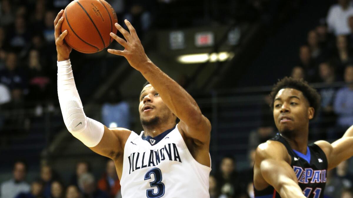 Villanova guard Josh Hart (3) gets past DePaul guard Eli Cain for a layup during the first half Wednesday.