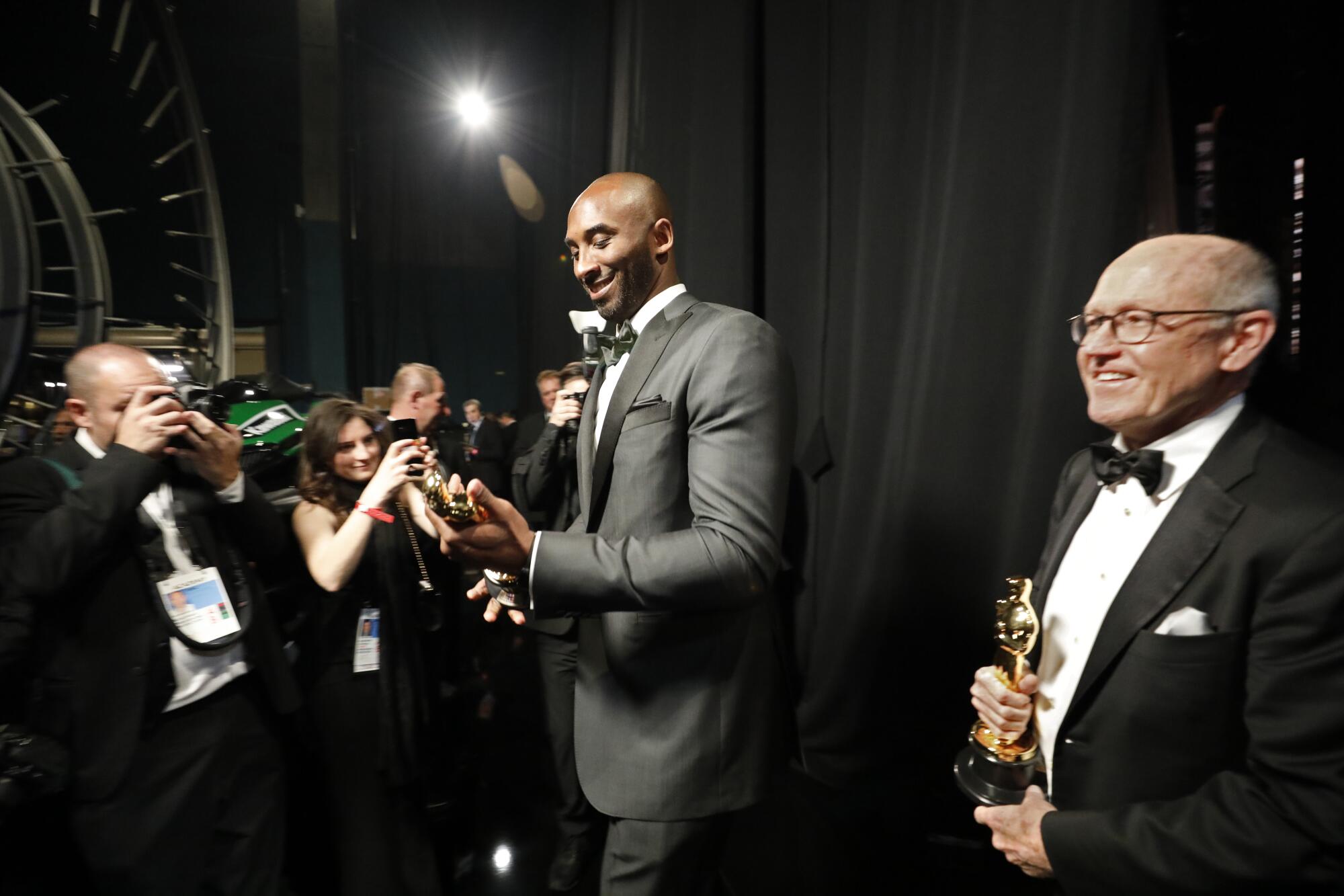 2018: Kobe Bryant admires his statue after winning the animated short film Oscar with Glen Kean, right, for "Dear Basketball"