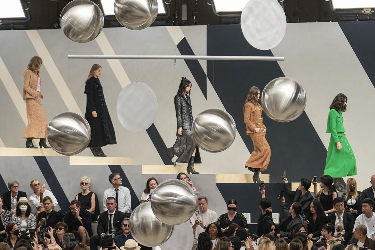 Models wear creations as part of Chanel's Haute Couture Fall/Winter 2022-2023 fashion collection presented Tuesday, July 5, 2022 in Paris. (AP Photo/Michel Euler)
