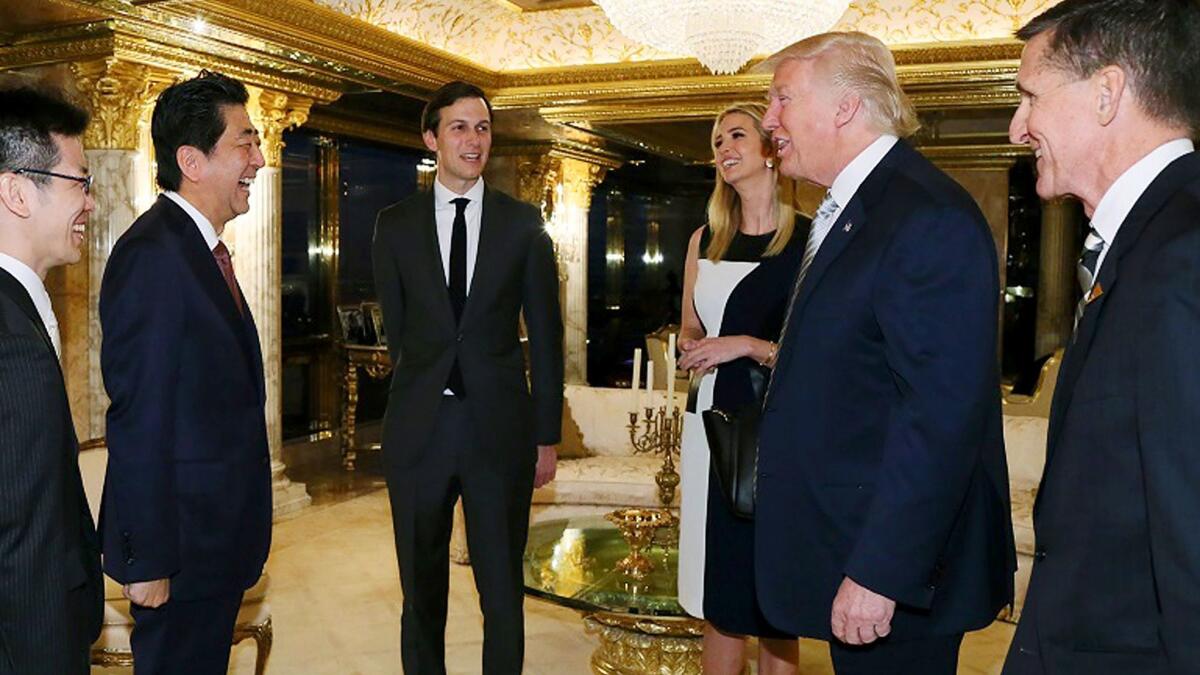 Japanese Prime Minister Shinzo Abe, second from left, is welcomed by President-elect Donald Trump, second from right, in New York.