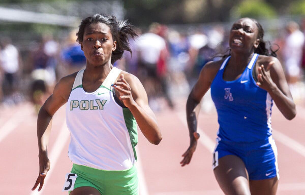 Long Beach Poly's Arianna Washington, left, pulls ahead of Long Beach Jordan's La Troya Franklin to win the 100 meters in the Southern Section Division I meet.