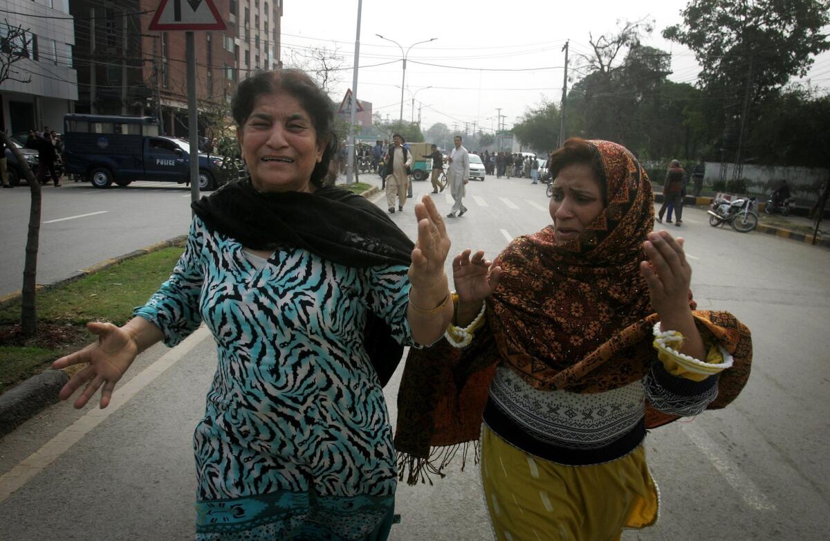 Pakistani women run after a bombing in the city of Lahore on Feb. 17.