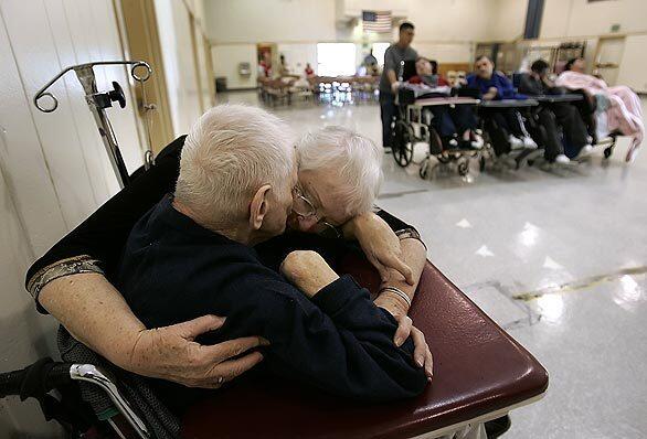 Sister Nuala Ryan, right, works to communicate and comfort a client at a recent Sunday service at Lanterman Developmental Center in Pomona. After 23 years as the center's music therapist and Catholic chaplain, Ryan is retiring in two weeks.