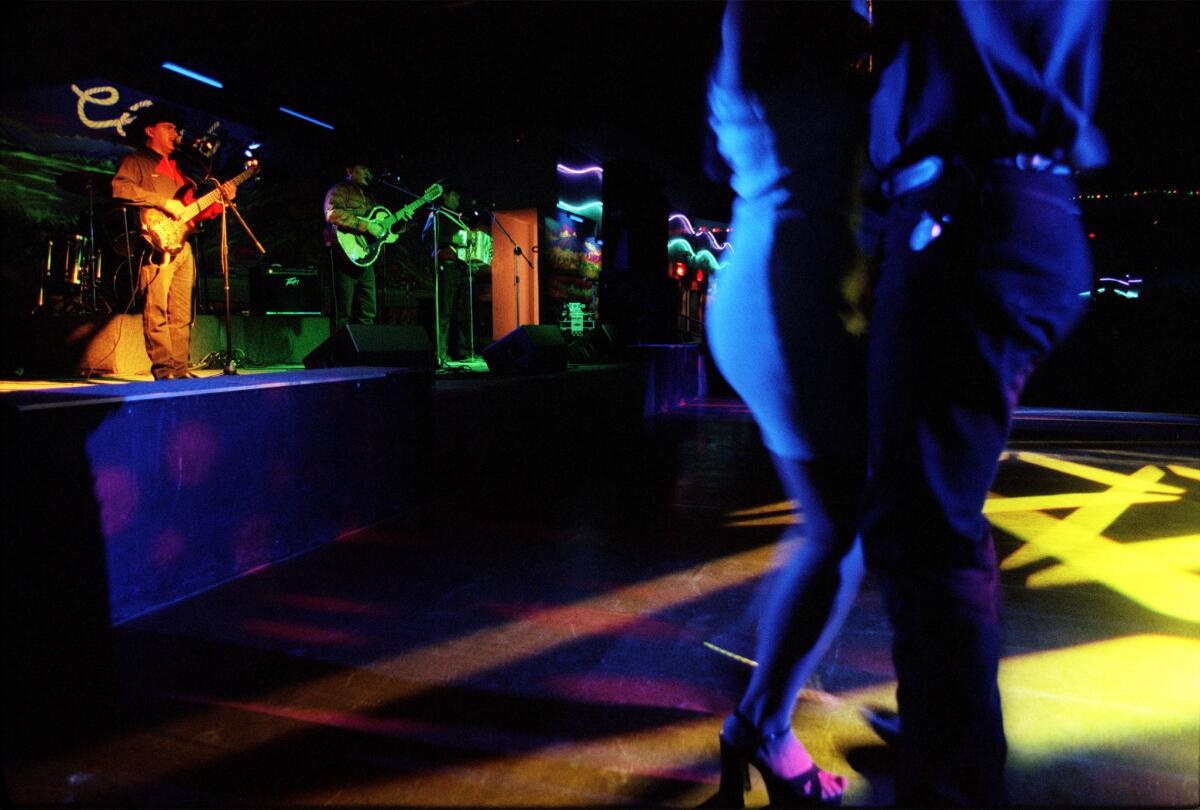 Dancers at El Rodeo nightclub in Pico Rivera listen to live music. The club's owner has agreed to plead guilty to laundering money as part of a drug-trafficking ring.